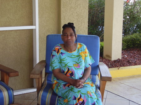 Mollie seating in chair in front of Holiday Inn