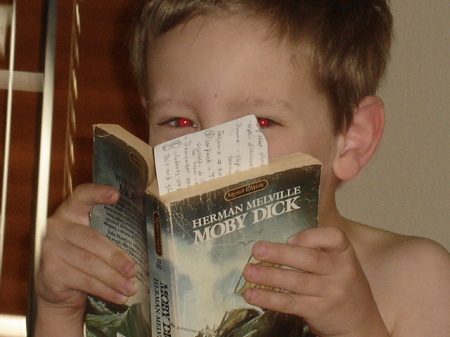 Like father, like son . . . Spence takes in some light reading . . .
