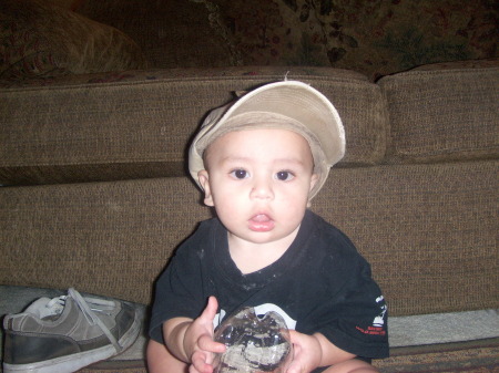 Logan wearing daddys hat