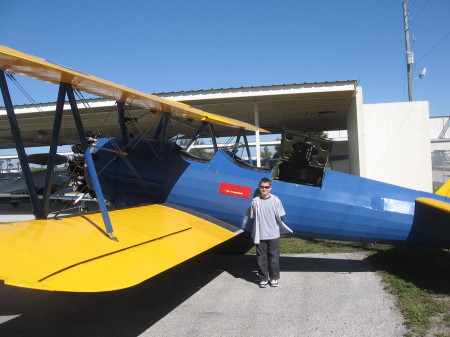 Jordan standing in front of Grandpa's biplane in Stuart, Florida.