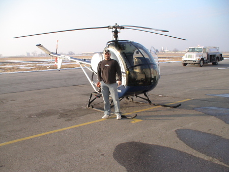 Me and one of the helicopters that I fly.