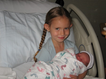 Brittany holding her brother Trevor the first time.