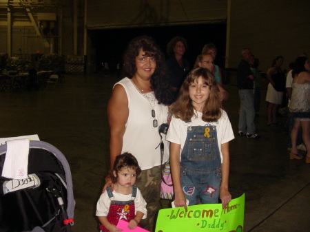 Me and my girls waiting in an airplane hanger