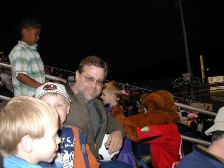 The old man at the ball park with the kids.