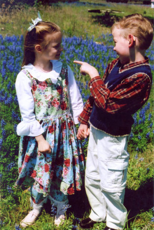 Sarah and Gabriel laughing in a field of Texas Bluebonnets.