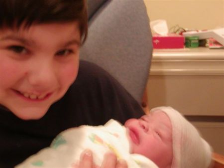 Big brother Trevor holding newborn Travis
