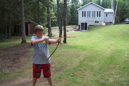 tring to teach my 11yr old how to hold a bow,,,,lol oh my head