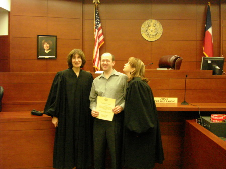 A proud mama kissing on his newly sworn-in attorney son