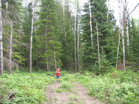 Robby hikes into the clearing for the vacation home...