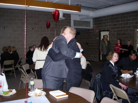 Chris and Brian sharing an embrace