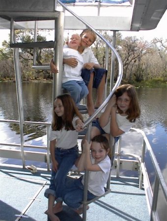 All the kids on the stairs of the houseboat
