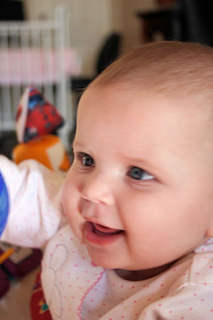 Baby playing in her exersaucer