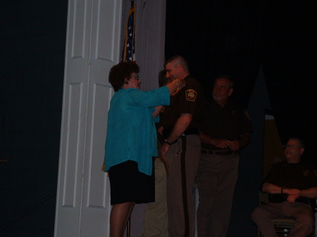 MOM Pinning on my badge at Graduation