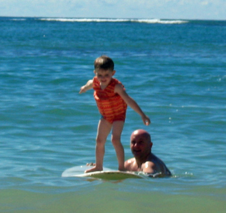 Dad teaching Blake to surf