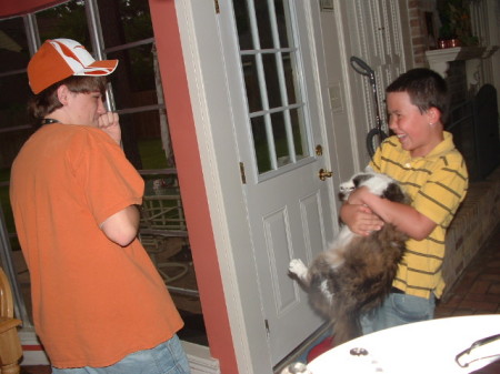 Zack and brother Jamey playing with the cat