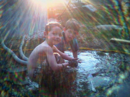 Tallon and Jayden playing in the mud.