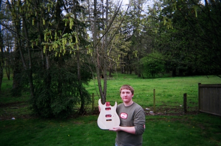 Austin and the guitar he is building