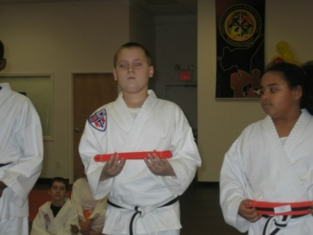 Nicholas getting Orange Belt Promotion