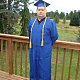 Kent proudly standing in his cap and gown on our back porch