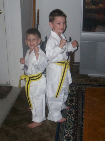 my grandsons after receiving their second-degree yellow belt from their father who is a third degree  black belt