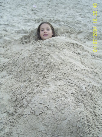 Christina buried in sand