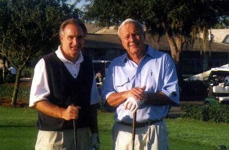 Ken playing golf with Arnold Palmer