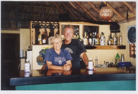 Kim and David behind the bar at their restaurant in Mexico.