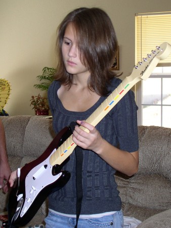 My youngest daughter playing guitar on Xbox