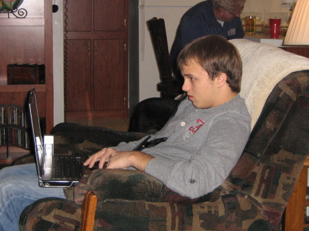 Travis on the computer, like always