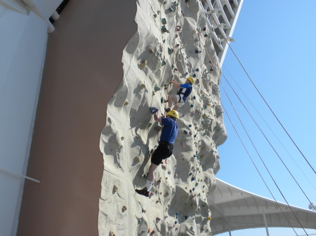 Climbing a rock wall on a cruise to Mexico