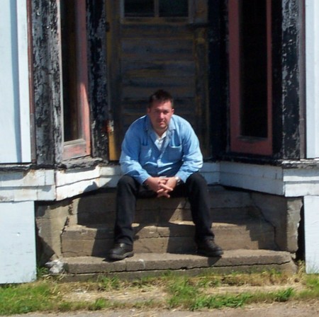 Me at an old store front in Cape Breton