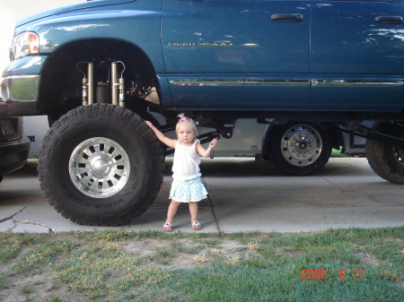 Hadley standing by dads lifted truck