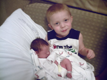 Malachi holding 1 day old Gabriel