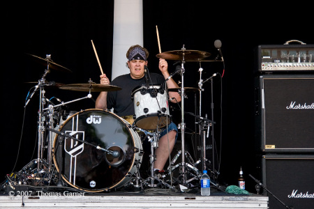 Ivin playing drums with his band