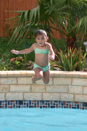 My granddaughter swimming in our pool!