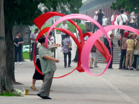 Ladies doing a ribbon dance in the park