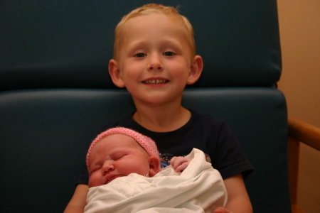 Riley holding his new baby sister Reese