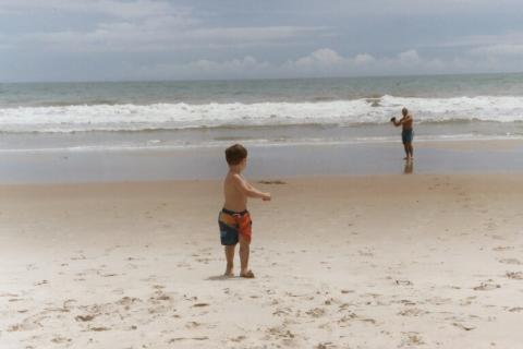 Rick/Kevin playing football on the beach