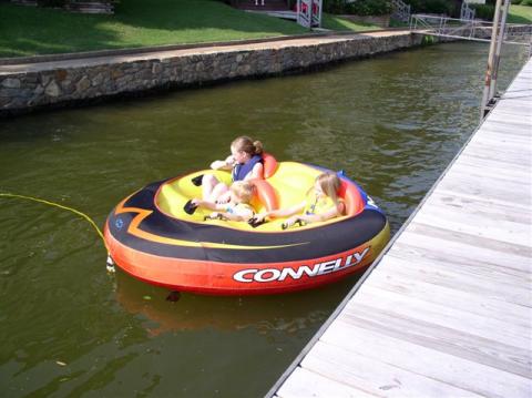 Richards children getting ride on Toms tube Sunbay Resort