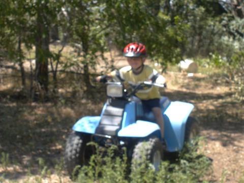 Tyler:Riding his 4 wheeler July 04