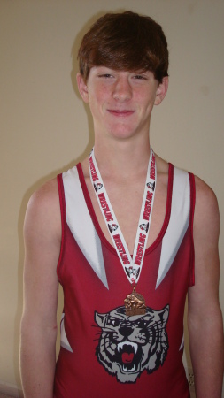 Benji in his singlet with his medal