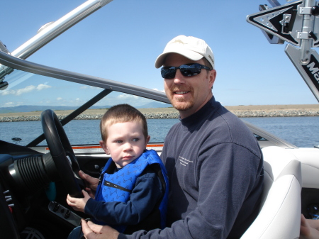 Tyler driving the boat with "Grandpa"