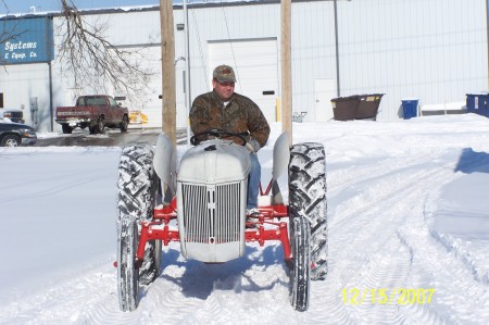 My husband on our tractor from Grandpa