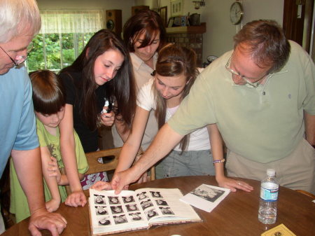 Brad and family looking thru yearbook