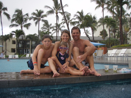 family in the rain pool