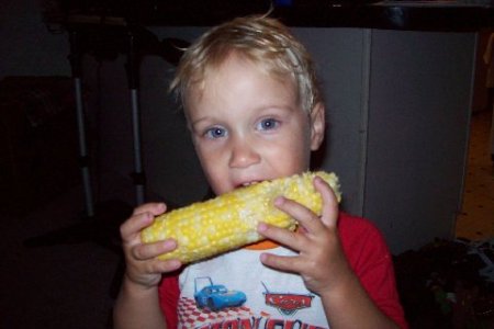 2 year old eating corn