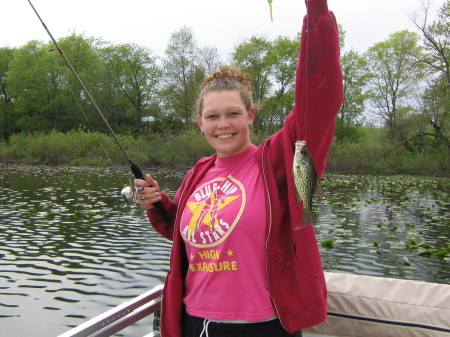 Nikki catching a fish at the lake