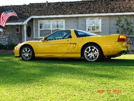 yellow nsx in front of house