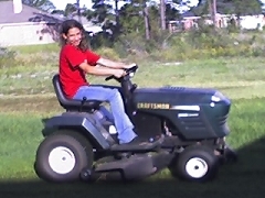 My daughter Melody learing to cut the grass