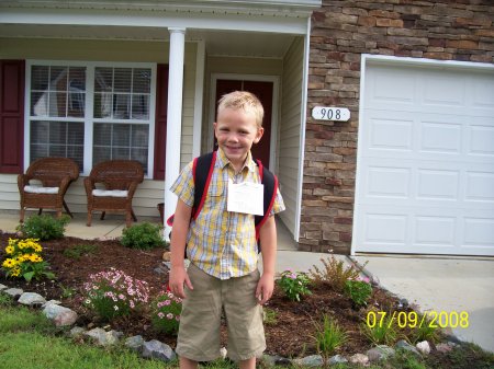 Nathaniel outside house on 1st day of Kinder.